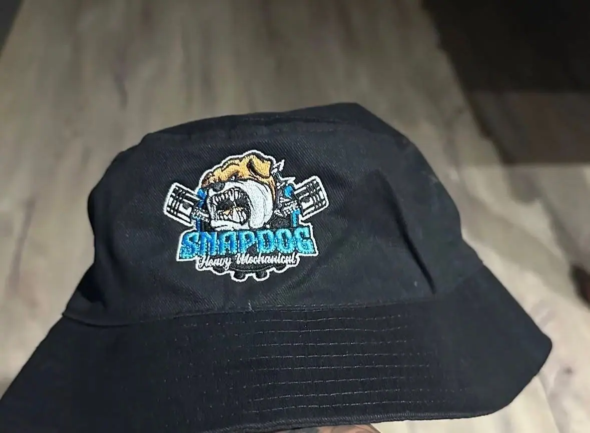 A black SnapDog bucket hat with the embroidered bulldog logo on the front.
